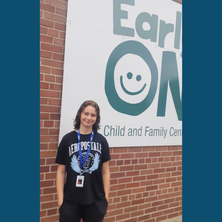 a photo of student Erica in front of an Early On sign